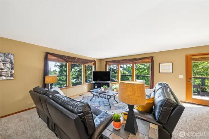 Walls of windows frame the view and the Autumn leaves.  The custom design of the home and quality finish work highlight the views and welcome each season into the main living spaces.