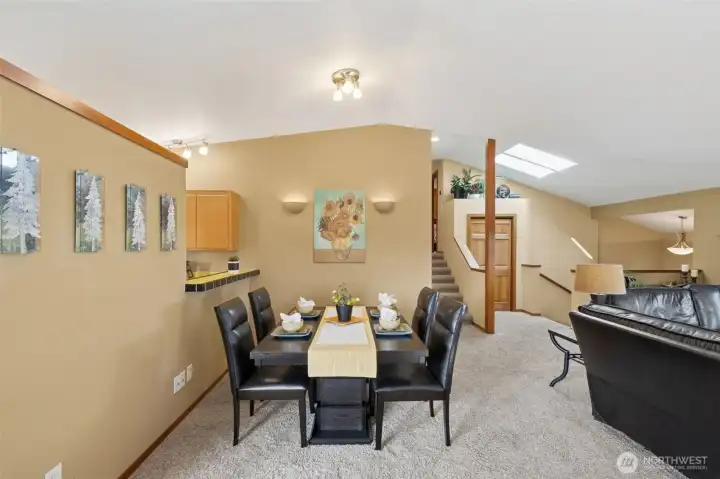Imagine your favorite table arrangement and next dinner party here. Beyond the dinning space find the short stairway to the 3 bedroom upper level.