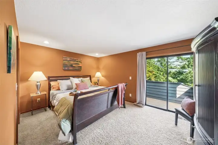 The primary suite offers designer tone paint finishes, a sliding door to a private view deck and plenty of wall space for your bedroom suite furnishings.