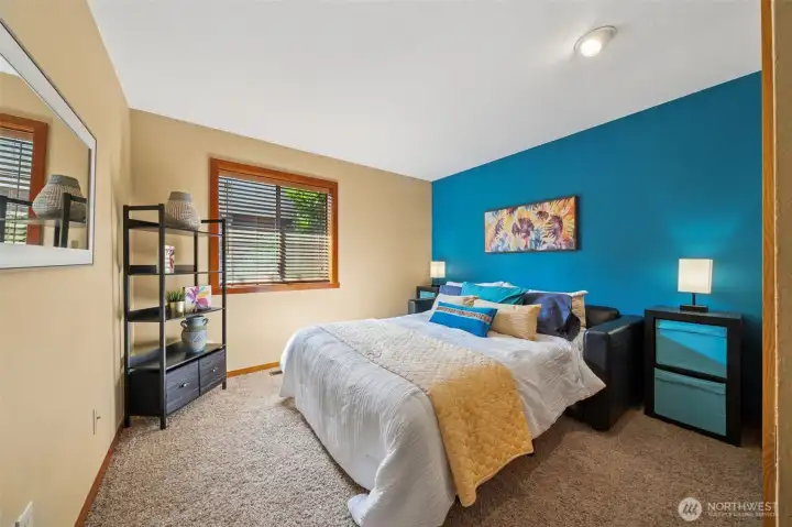 Bedroom 2 offers a guest space or media room as shown by this pull-out couch option. The room includes a large closet also.  Wood blinds are featured on all windows in the home.