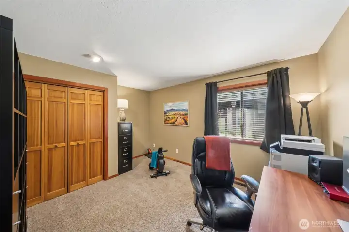 The third bedroom doubles as a full time home office space with room for exercise too!  The large, handsome, storage shelf unit is included or can be removed at buyer's request.