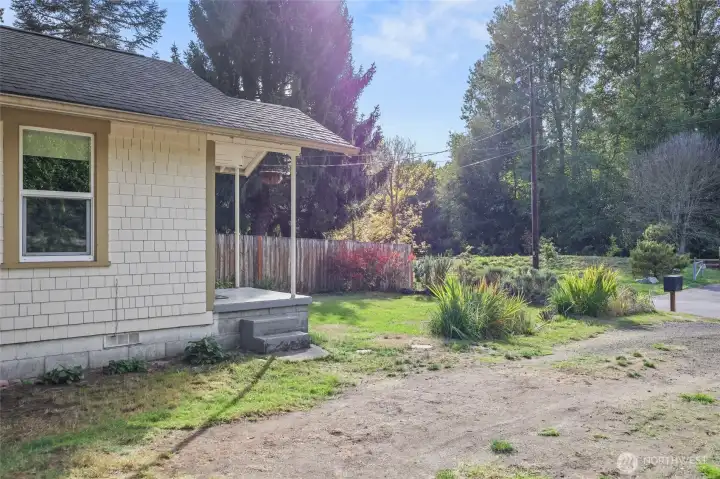 Lovely front yard gives a pretty visual, and also provides blueberries and raspberries, with annual blooms like crocosmia, lavender, daisies, and more!