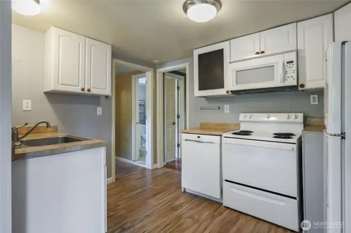 The kitchen is so perfect!  Fresh white cabinets, and all appliances stay, including the Bosch dishwasher (quiet as a mouse!). Chalkboard cabinet is a fun touch for messages, grocery lists, or favorite quotes. :)