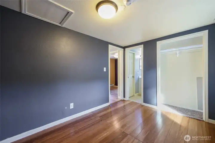 Closet and bathroom access ahead, as well as a peek into the office.