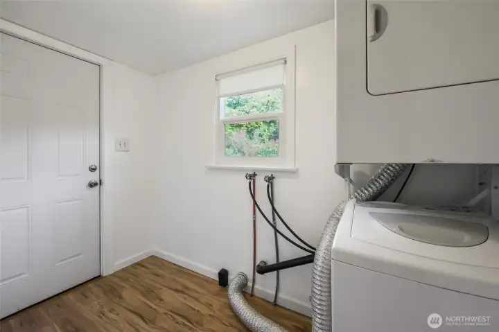 Through the office is this wonderful, recently enclosed addition--laundry room and indoor storage space The window brings in light, and the door provides convenient access to the back patio and yard...