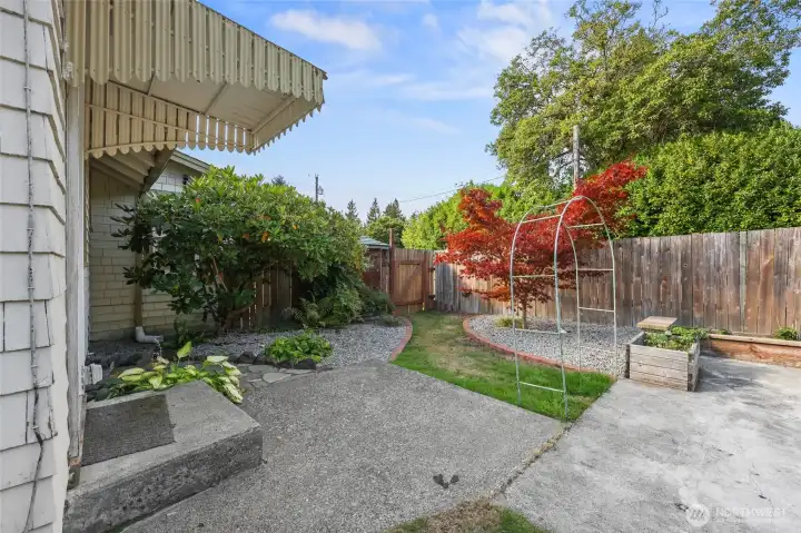 Perfectly designed for maximum enjoyment, this patio, pathway, arbor, and stone walkway to water spout on the left provide a wonderful setting.