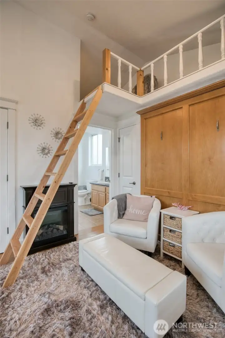 Bathroom with laundry is below the loft and adjacent to the murphy bed.