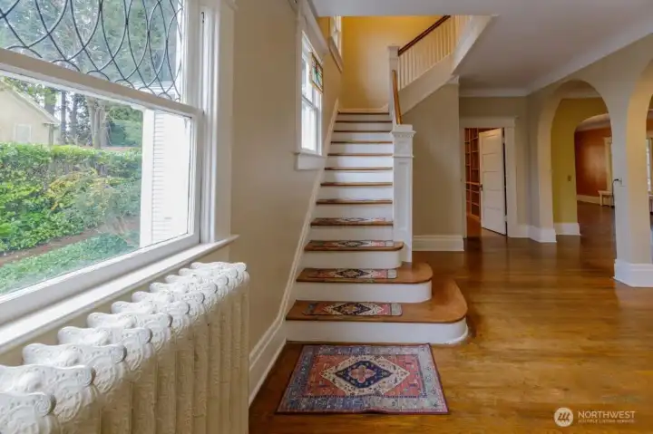 Radiators offer even heating. Beautiful staircase welcomes you into the home and invites you to stay awhile.