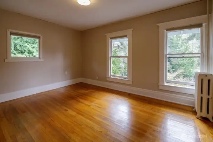 Second bedroom upstairs with wood floors, large closet, and lots of windows.
