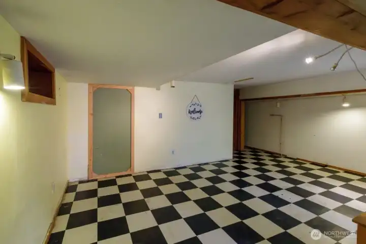 Large basement with mechanical room holding the boiler and the hot water heater, is spacious enough for crafting, storage, or?