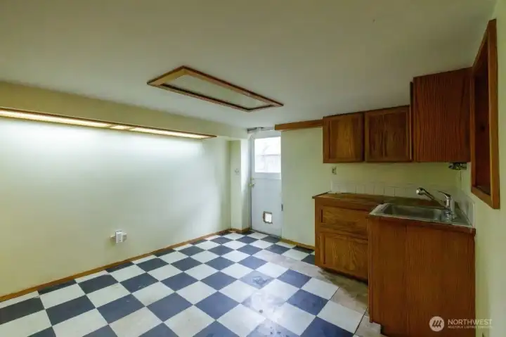 Exterior entry into the basement with kitchenette.