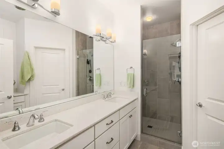 The luxurious primary bathroom offers three vanities for added convenience and a walk-in shower for a serene, private escape.