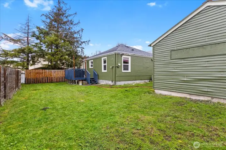 Expansive, fully-fenced backyard with plenty of room for play or gardening.