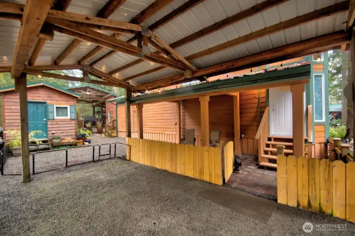 COVERED PORCH WITH PAVERS AND A CARPORT