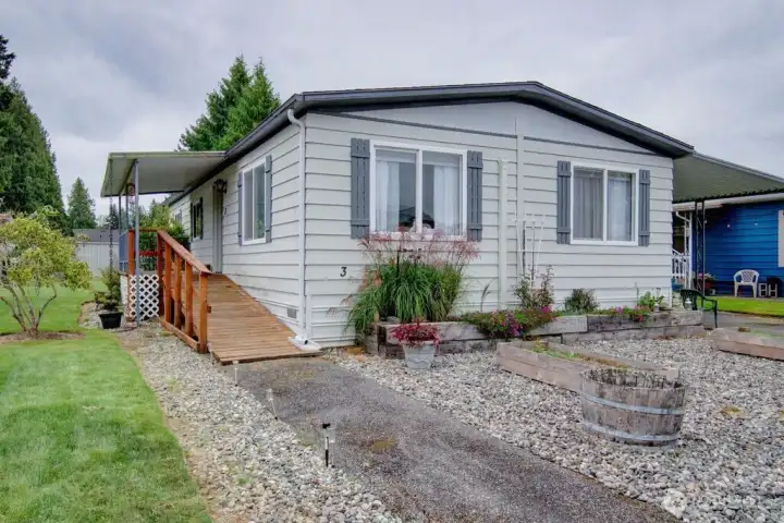 East view of home with ramp to the covered porch & front door.