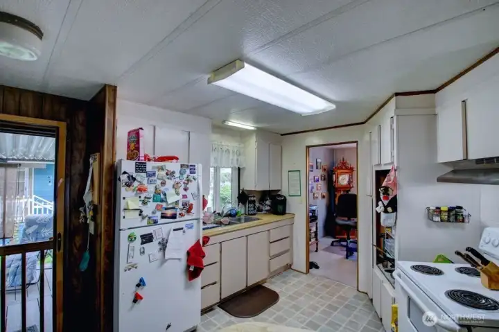 Kitchen with door to the large deck. Dining room off kitchen.