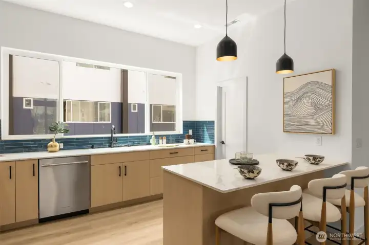 Seated counter, quartz countertops, tile backsplash, stainless steel appliances! Photo is of model home of same floorplan.  Color schemes and finishes will vary per plan.