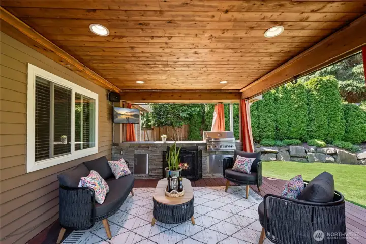 Oasis on the covered deck that has build-in BBQ station with fireplace & a mini fridge