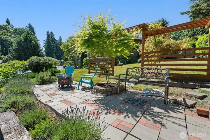 More sitting area with pergola and firepit