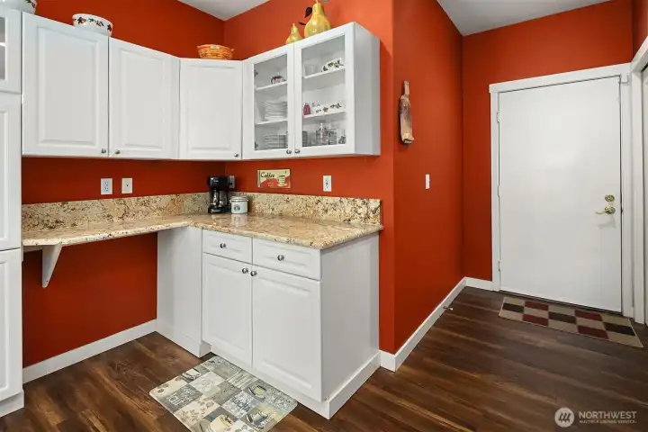 A built in work station in the kitchen / To the right is the garage door coming into the kitchen A built in work station in the kitchen / To the right is the garage door coming into the kitchen