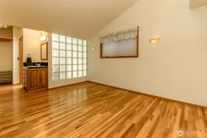 Primary bedroom with a glass wall dividing the bath from the rest of the room.