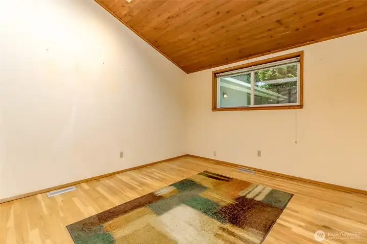 Another angle of the second bedroom--lovely hardwoods and a pine ceiling!