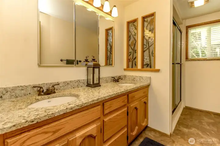 Main bath with granite and dual sinks.