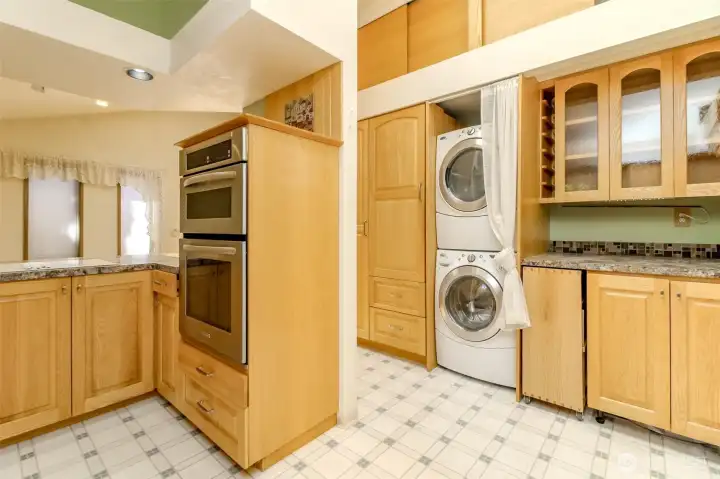 Kitchen and pantry area. Newer stacking washer and dryer stay with the home.