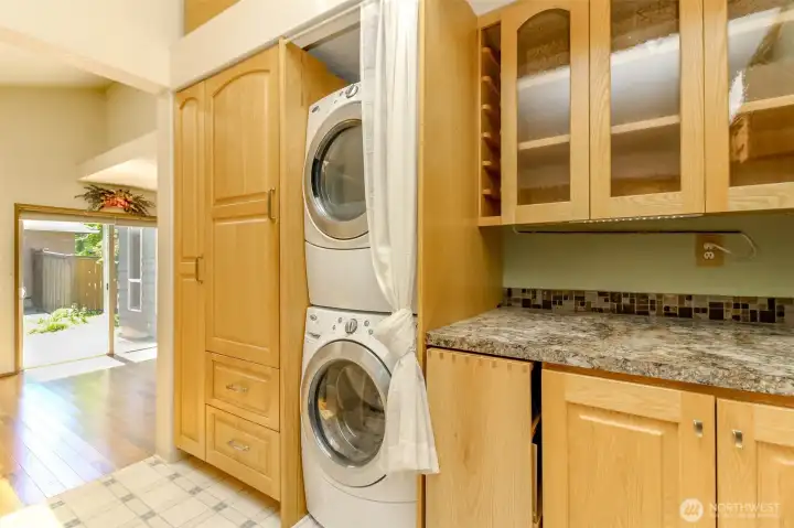 This picture shows the kitchen in relation to the dining area and a lovely brick side patio.