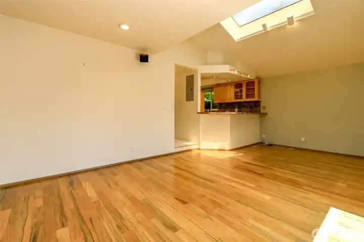 Look at those floors!  View of the kitchen with dining area off to the right.