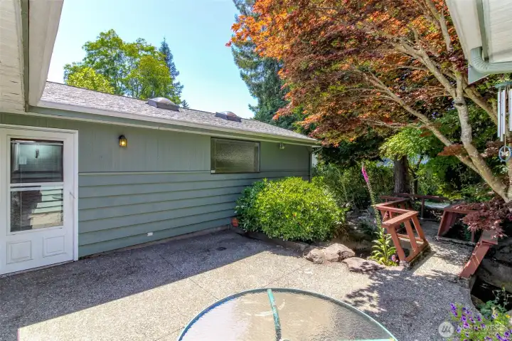 View of the side door and garage from the back patio.