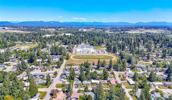 The home is the gray roof right at the bottom edge, center of pic.  Do you see the plane?