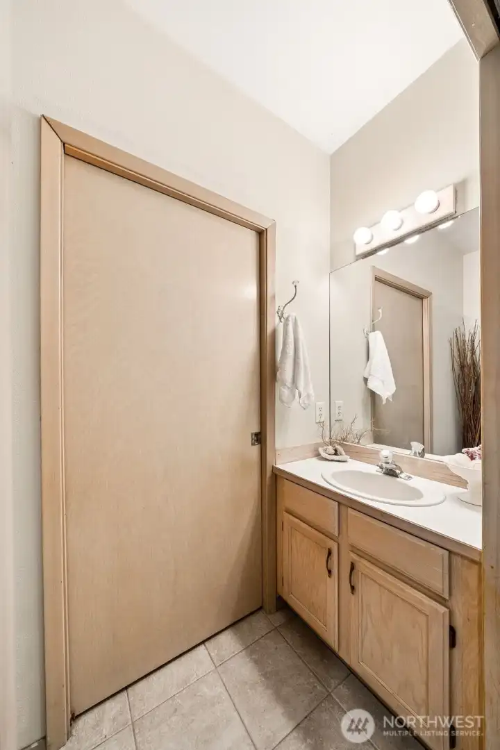 Half bathroom on the main floor with pocket door that opens to the laundry. Half bathroom on the main floor with pocket door that opens to the laundry.