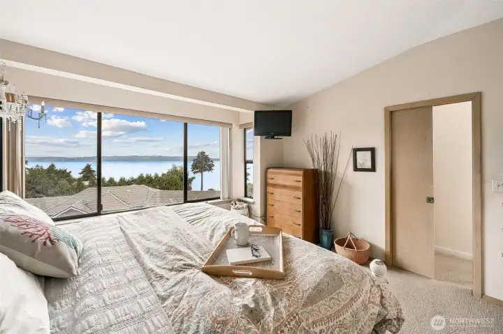 Primary bedroom with views of Vashon Island. Walk-in closet and ensuite bathroom. Primary bedroom with views of Vashon Island. Walk-in closet and ensuite bathroom.