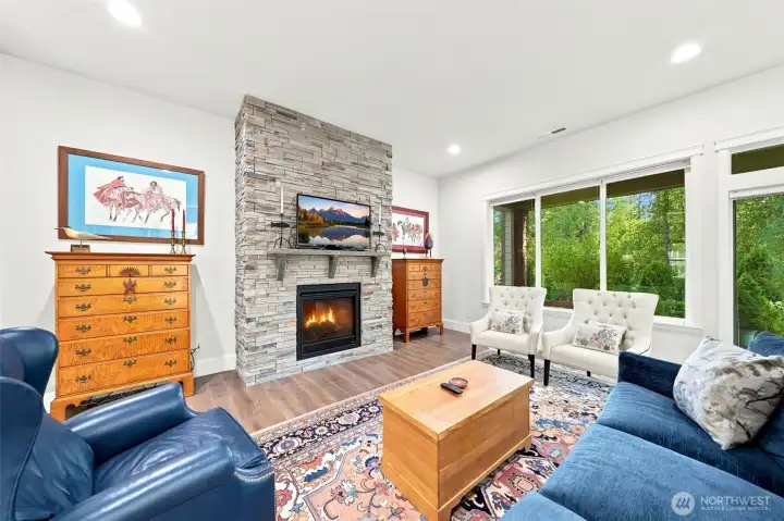 The 10 foot ceilings make the stacked stone, floor to ceiling, gas fireplace feel even more grand. Whole house air conditioning will keep you cool in the summers!