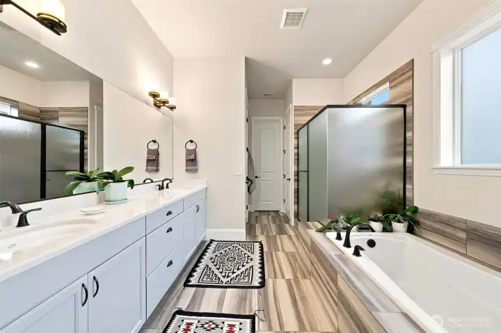 Wonderfully deep soaking tub, frosted glass shower, tile floors, tub and shower surround, double sinks, private water closet, storage closet and walk-in closet. This bathroom meets every need!