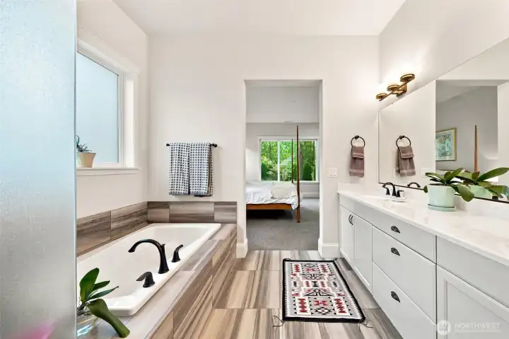 The frosted glass shower has a built in bench seat.