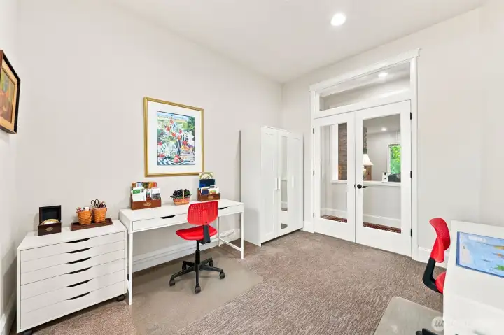 Glass french doors and additional transom window let light flow through the living spaces.
