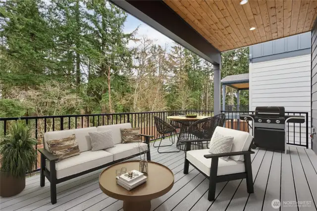 Main floor deck off kitchen overlooks verdant greenbelt.