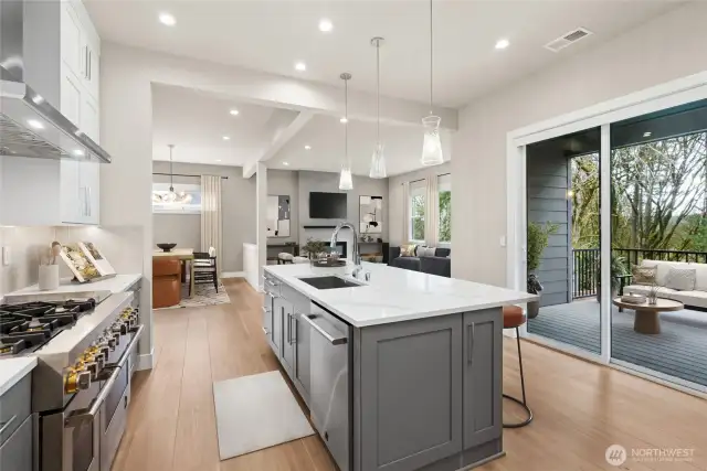 The kitchen looks out to the covered Trek deck and green space