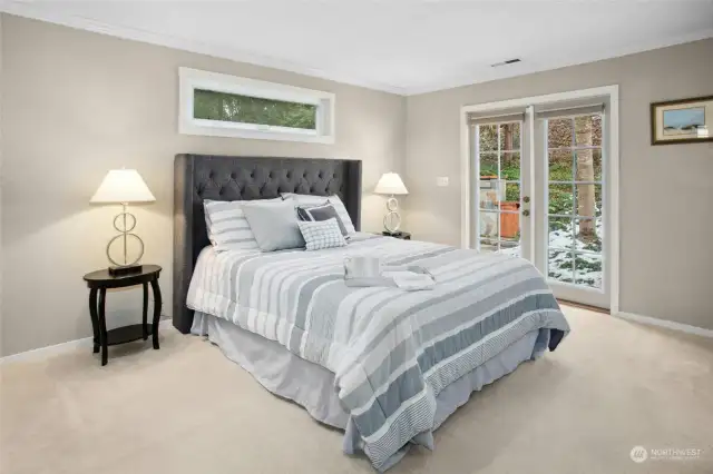 The primary bedroom has French doors out to the back yard and fountain.