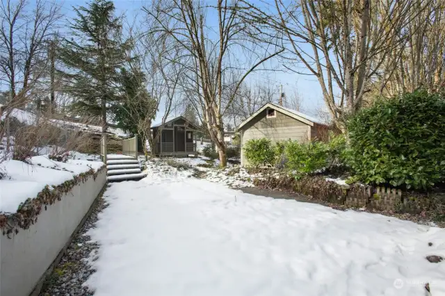 Back yard showing bridge to gazebo.  Garden shed/shop is to the right.