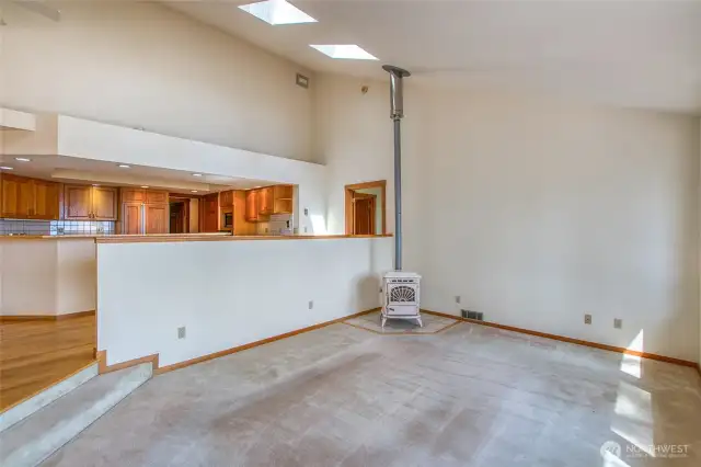 The living room is slightly sunken with a pellet stove for ambinace and warmth.