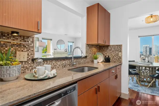 Granite counters and stainless steel appliances—this kitchen is ready for weekday meals and weekend hosting.