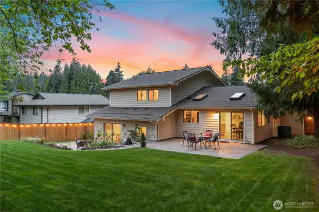 Incredible backyard with two patios, fountain, cafe lights, and mature landscaping!
