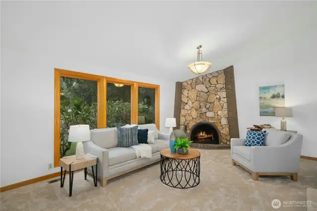 Living room with stylish fireplace. High end double pane Anderson windows & doors throughout home.