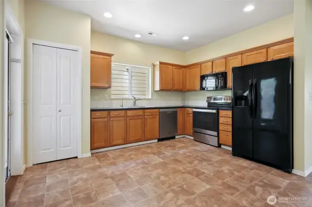 Open kitchen with all new vinyl. All appliances stay.