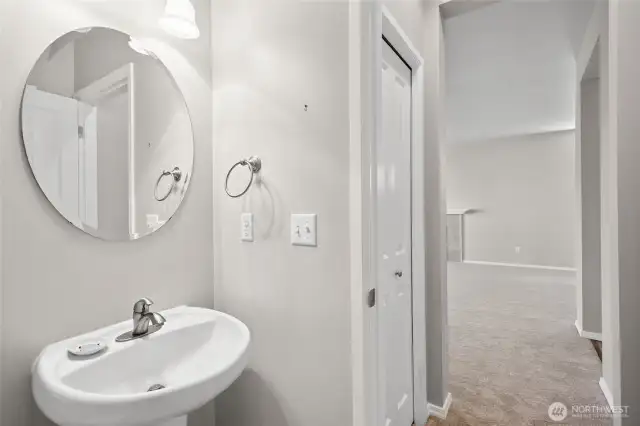 Back inside and adjacent to the living space is your 1/2 bath with linen closet.
