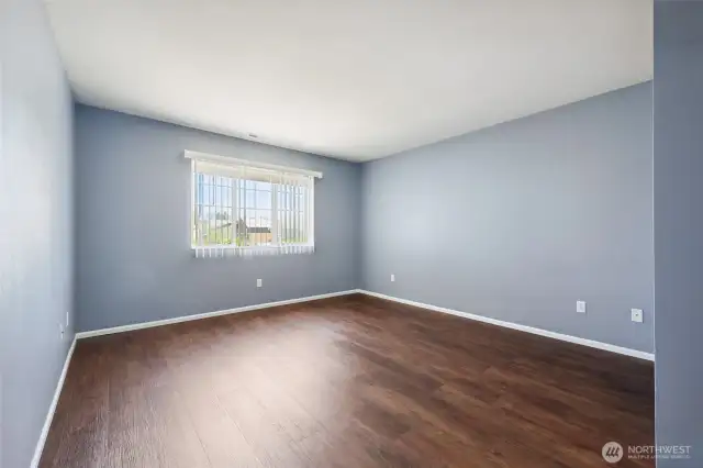 Primary bedroom with LVP flooring.
