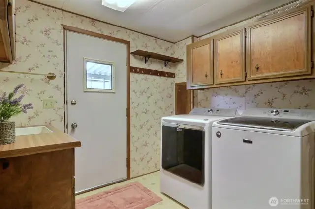 Side door enters into the laundry/mudroom with a newer washer and dryer included in the sale of home.